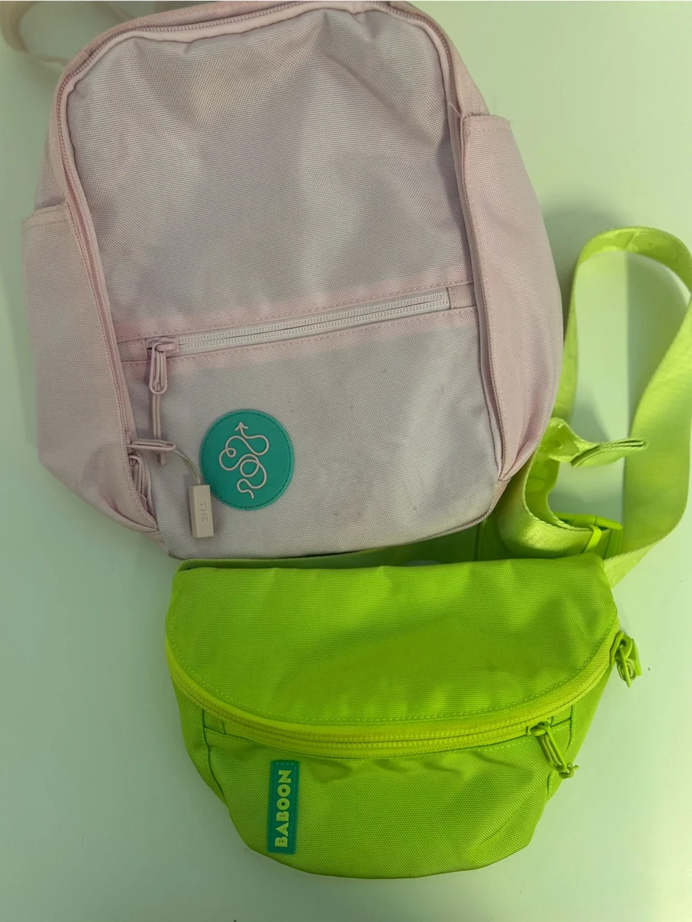 Baboon to the Moon Neon Green Waist Bag and Pink Mini Backpack Bag Duo